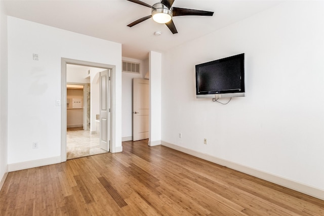3818 Holland Ave Unit 305, Dallas, TX 75219 - unfurnished bedroom featuring light wood finished floors, baseboards, a ceiling fan, and visible vents