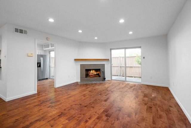 851 Dublin Dr Unit 3, Richardson, TX 75080 - unfurnished living room featuring wood finished floors, recessed lighting, a lit fireplace, and baseboards