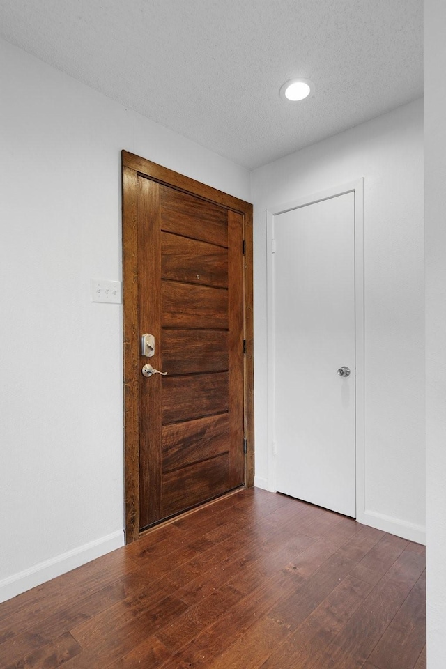 851 Dublin Dr Unit 3, Richardson, TX 75080 - foyer entrance with wood finished floors, baseboards, a textured ceiling, and recessed lighting