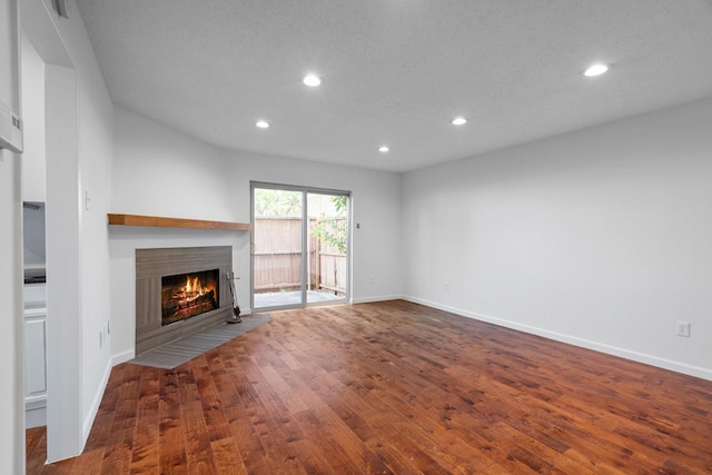 851 Dublin Dr Unit 3, Richardson, TX 75080 - unfurnished living room with a fireplace with flush hearth, recessed lighting, wood finished floors, and baseboards