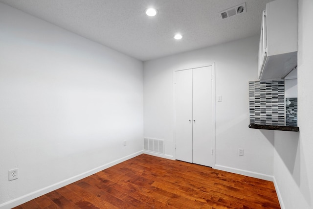 851 Dublin Dr Unit 3, Richardson, TX 75080 - unfurnished bedroom featuring recessed lighting, dark wood-style floors, baseboards, and a textured ceiling