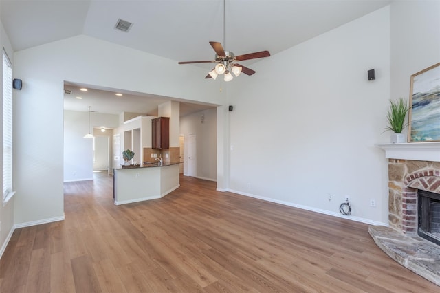 5208 Birchwood Dr, Mckinney, TX 75071 - unfurnished living room featuring visible vents, light wood-style flooring, a ceiling fan, and a fireplace