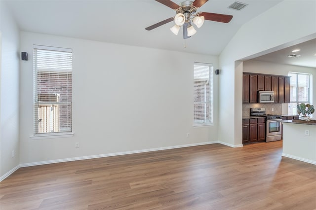 5208 Birchwood Dr, Mckinney, TX 75071 - unfurnished living room with light wood-type flooring, a ceiling fan, vaulted ceiling, visible vents, and baseboards