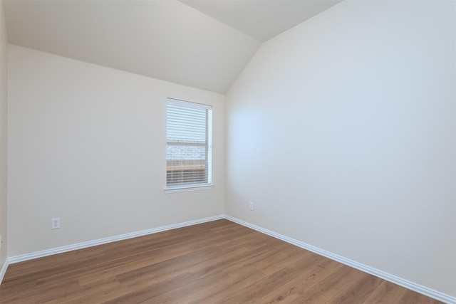 5208 Birchwood Dr, Mckinney, TX 75071 - empty room with baseboards, light wood-type flooring, and vaulted ceiling