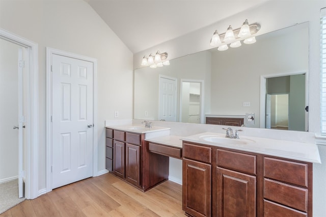 5208 Birchwood Dr, Mckinney, TX 75071 - bathroom with wood finished floors, double vanity, a sink, and lofted ceiling