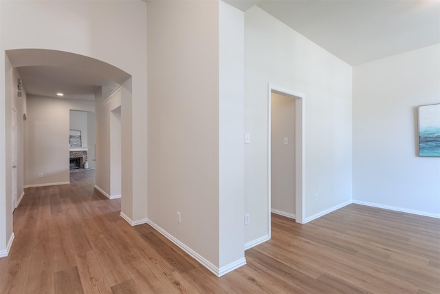 5208 Birchwood Dr, Mckinney, TX 75071 - hall featuring light wood-type flooring, baseboards, and arched walkways