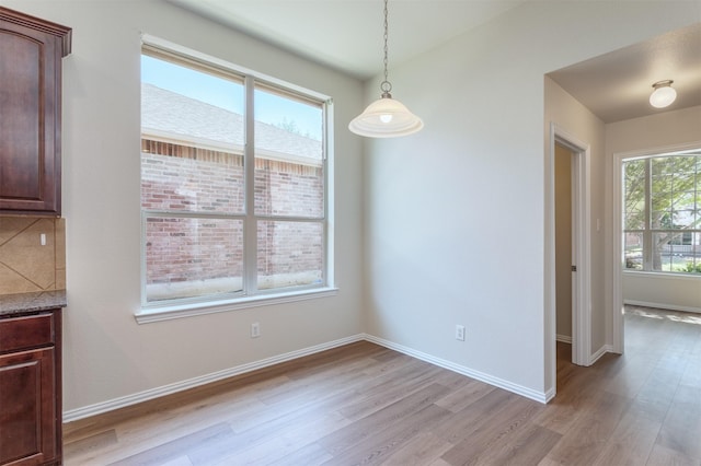 5208 Birchwood Dr, Mckinney, TX 75071 - unfurnished dining area with light wood finished floors and baseboards
