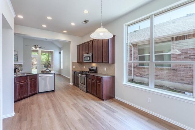 5208 Birchwood Dr, Mckinney, TX 75071 - kitchen with ceiling fan, visible vents, appliances with stainless steel finishes, light wood finished floors, and backsplash