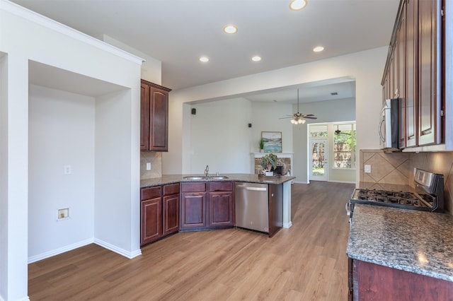 5208 Birchwood Dr, Mckinney, TX 75071 - kitchen with light wood-style floors, appliances with stainless steel finishes, a sink, and a ceiling fan