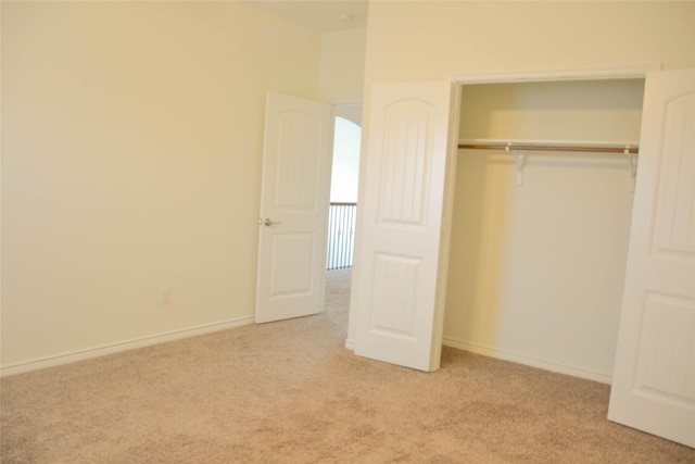 unfurnished bedroom featuring carpet floors, a closet, and baseboards