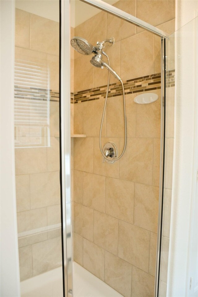 full bath featuring a shower stall