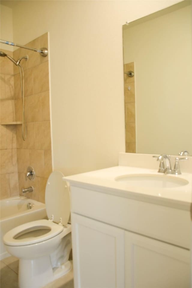 full bath with toilet,  shower combination, vanity, and tile patterned flooring