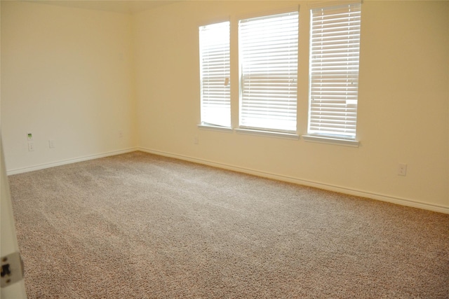 spare room with carpet floors and baseboards