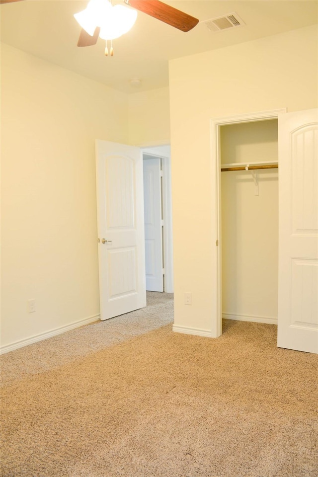 unfurnished bedroom featuring carpet flooring, a closet, ceiling fan, and baseboards