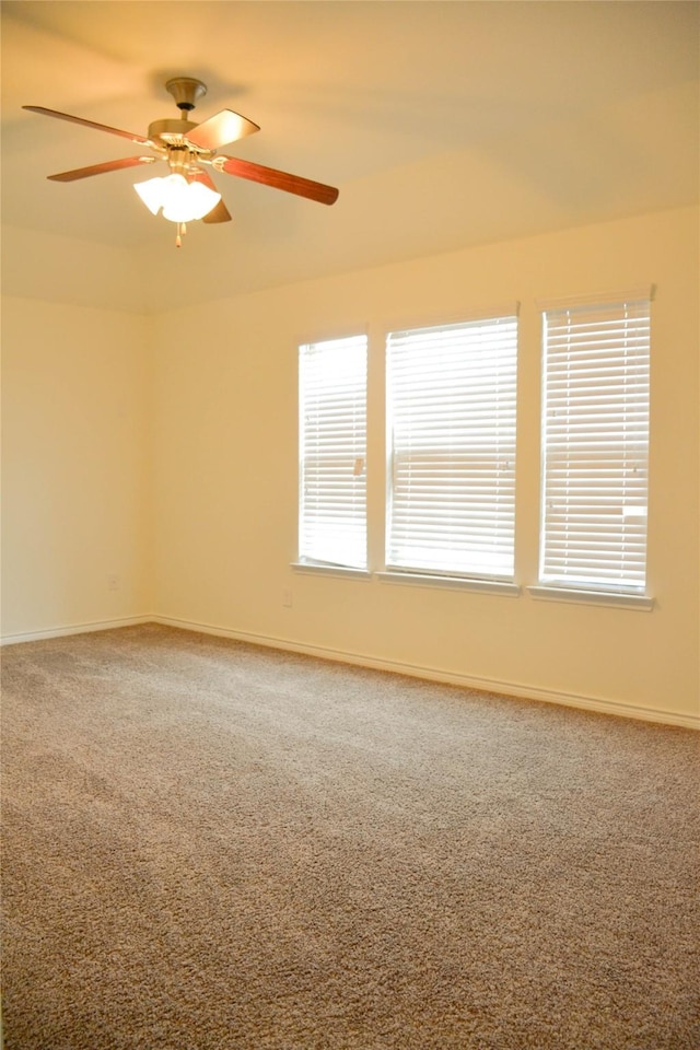 unfurnished room with carpet flooring, ceiling fan, and baseboards