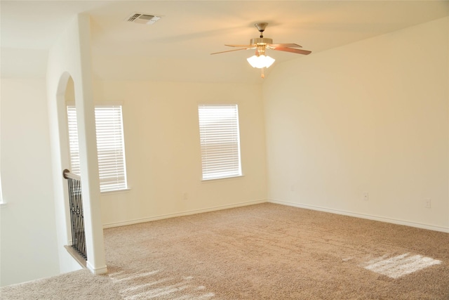spare room featuring carpet, a ceiling fan, and baseboards