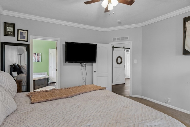 bedroom featuring visible vents, a barn door, carpet, and crown molding