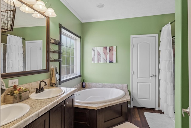bathroom featuring double vanity, a sink, crown molding, and a bath