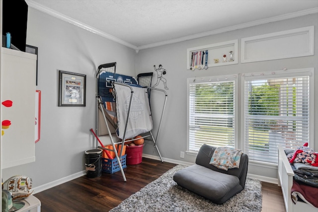 playroom with crown molding, baseboards, wood finished floors, and a wealth of natural light