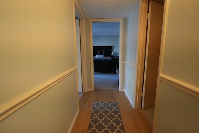 hallway with wood finished floors