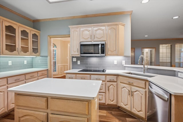 kitchen with appliances with stainless steel finishes, a sink, light brown cabinetry, light countertops, and crown molding