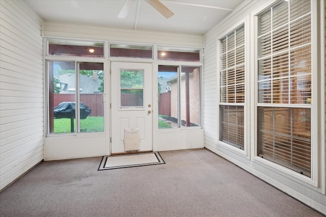 unfurnished sunroom featuring carpet floors