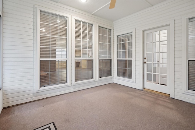 unfurnished sunroom featuring carpet floors