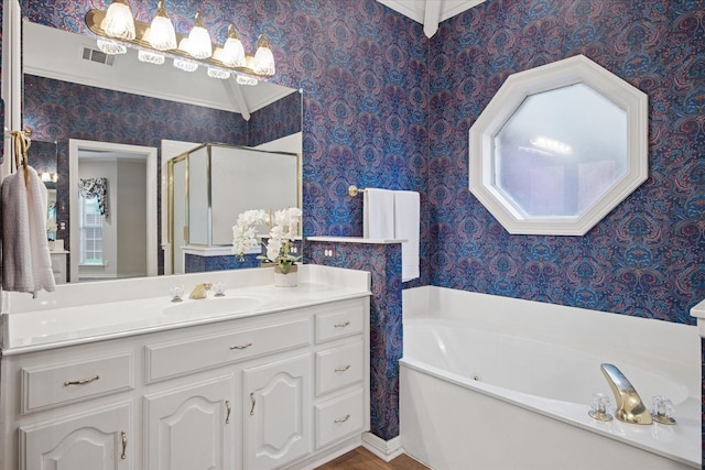 full bathroom with wallpapered walls, a garden tub, a shower stall, and vanity