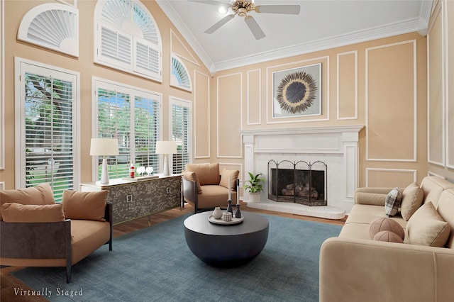 sitting room featuring a decorative wall, crown molding, a ceiling fan, lofted ceiling, and wood finished floors