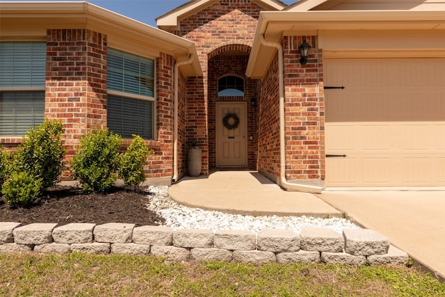313 Fairgrounds Ln, Ponder, TX 76259 - doorway to property featuring a garage, brick siding, and concrete driveway