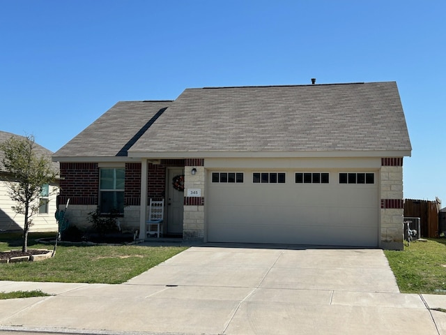 345 Wishbone Ln, Fort Worth, TX 76052 - view of front of house featuring a shingled roof, a garage, and stone siding
