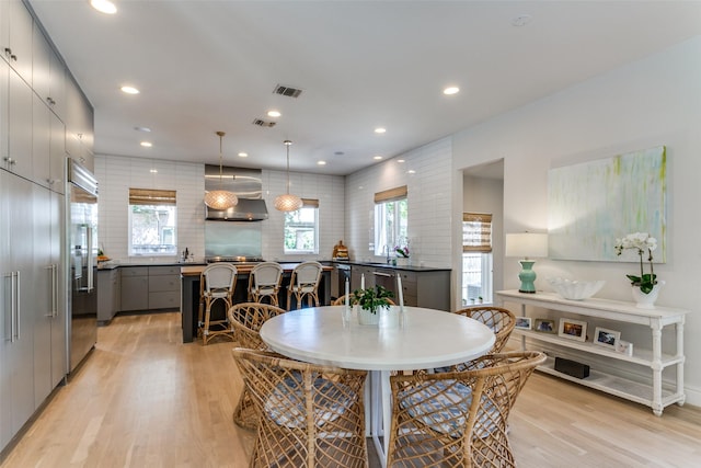dining room with recessed lighting, light wood finished floors, and visible vents