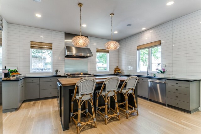 kitchen featuring wood counters, gray cabinetry, stainless steel built in refrigerator, and light wood-type flooring