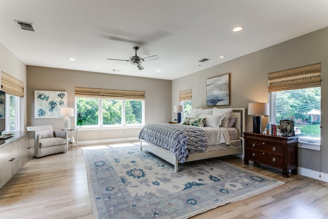 bedroom featuring visible vents, multiple windows, and light wood-type flooring