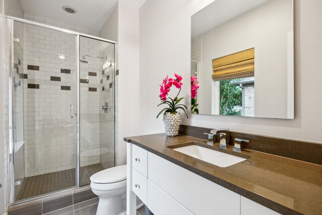 6604 Northridge Dr, Dallas, TX 75214 - bathroom with vanity, toilet, and a stall shower