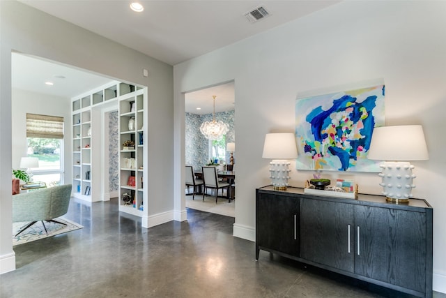 sitting room with visible vents, baseboards, recessed lighting, a chandelier, and concrete floors