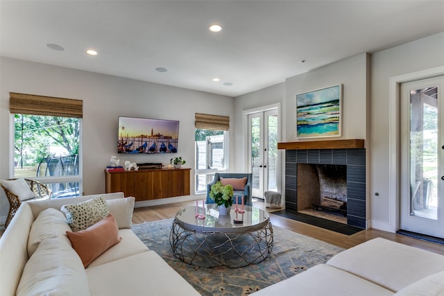 living room with recessed lighting, a wealth of natural light, and a fireplace