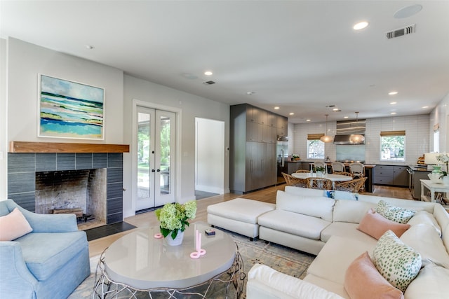 living room featuring recessed lighting, visible vents, and light wood-style flooring