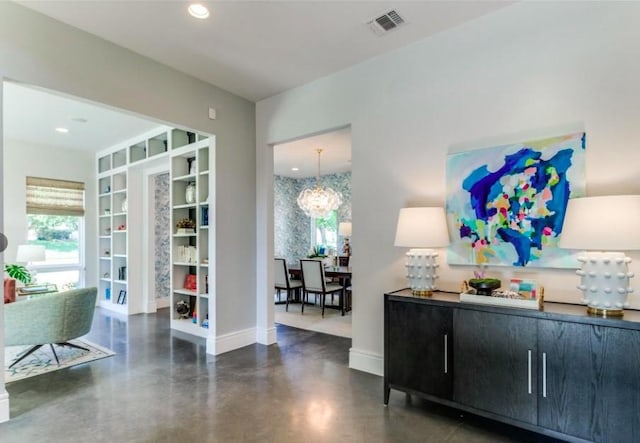 6604 Northridge Dr, Dallas, TX 75214 - sitting room featuring baseboards, finished concrete flooring, recessed lighting, and a chandelier