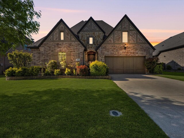 951 Highpoint Way, Roanoke, TX 76262 - french country inspired facade with concrete driveway, a yard, a garage, central AC, and brick siding