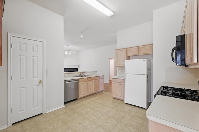kitchen featuring freestanding refrigerator, light brown cabinets, dishwasher, and black microwave