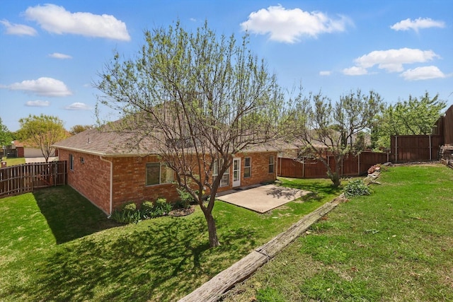 back of house featuring a patio, brick siding, and roof with shingles