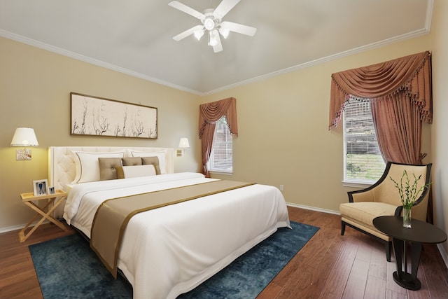 bedroom featuring multiple windows, crown molding, wood finished floors, and baseboards