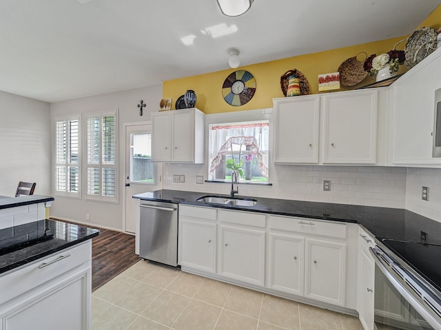 907 Chickesaw Ln, Wylie, TX 75098 - kitchen featuring stainless steel appliances, a sink, white cabinets, and backsplash
