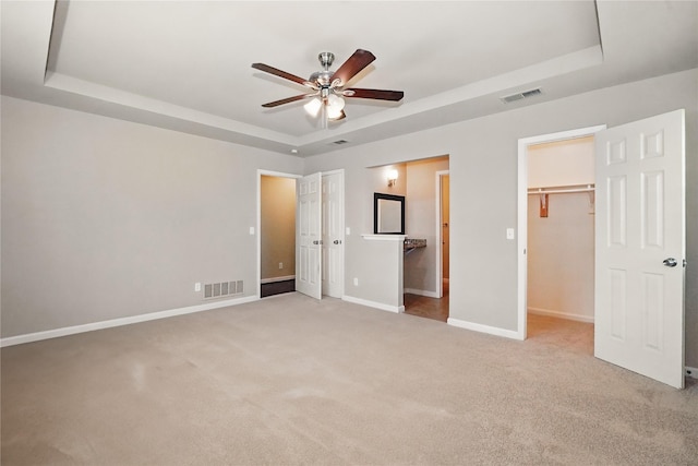 3321 Lynbrook Dr, Plano, TX 75075 - unfurnished bedroom featuring a raised ceiling, baseboards, visible vents, and carpet floors