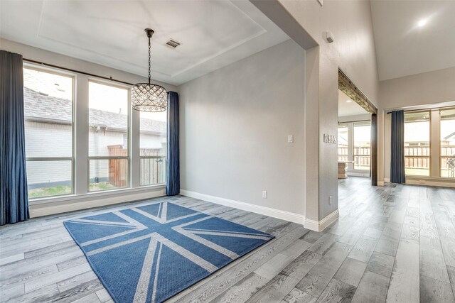 8321 Burnley, The Colony, TX 75056 - spare room with a chandelier, wood finished floors, and healthy amount of natural light