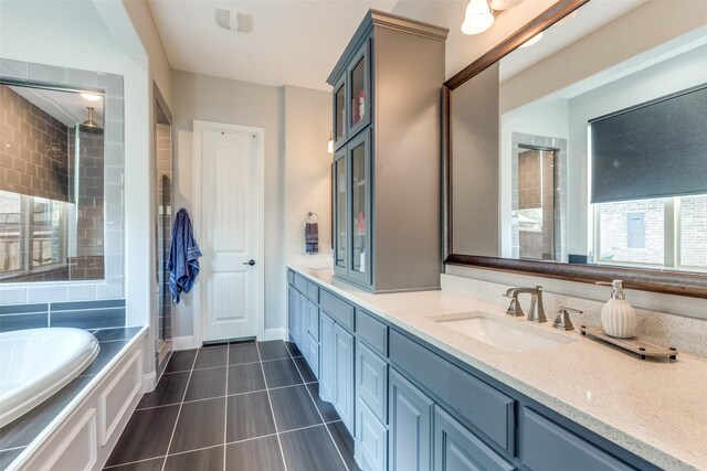 8321 Burnley, The Colony, TX 75056 - full bathroom featuring double vanity, a garden tub, tile patterned flooring, tiled shower, and baseboards