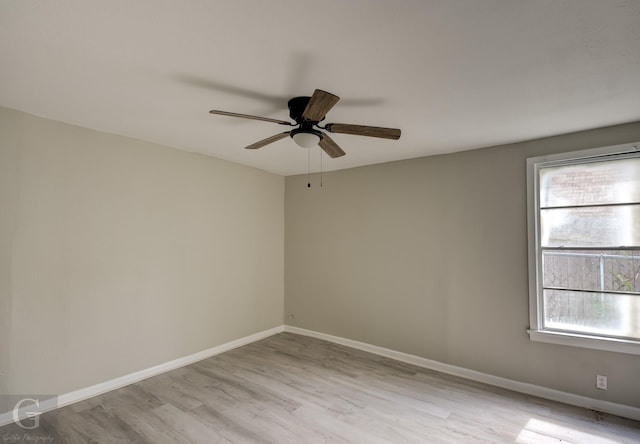 empty room featuring wood finished floors, ceiling fan, and baseboards