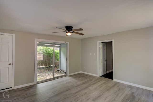 spare room with baseboards, a ceiling fan, and wood finished floors