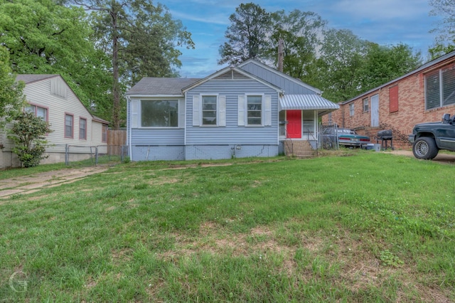 bungalow-style house featuring a front yard and fence